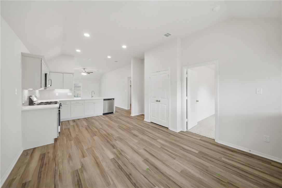 1220 High Street Navasota, TX 77868 - Photo 13 of 27 a view of kitchen and empty room with wooden floor