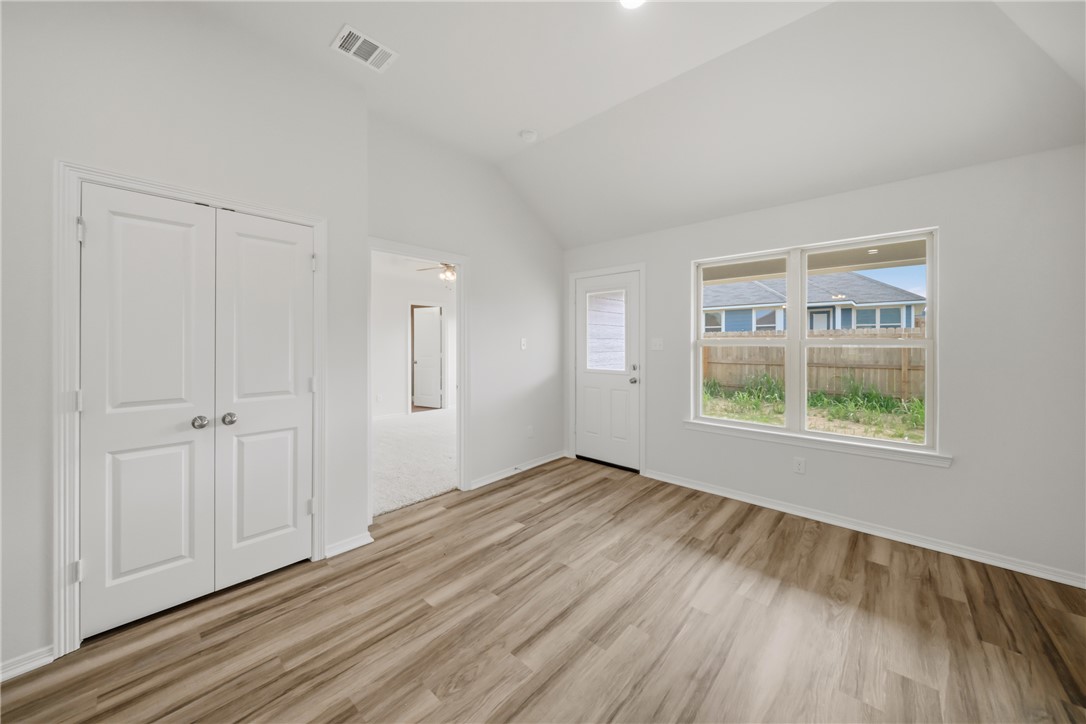 1220 High Street Navasota, TX 77868 - Photo 14 of 27 a view of an empty room with wooden floor and a window