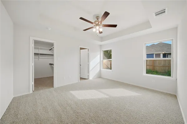 a view of a livingroom with a ceiling fan and window