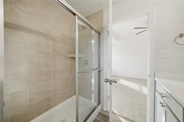 a bathroom with a glass shower door