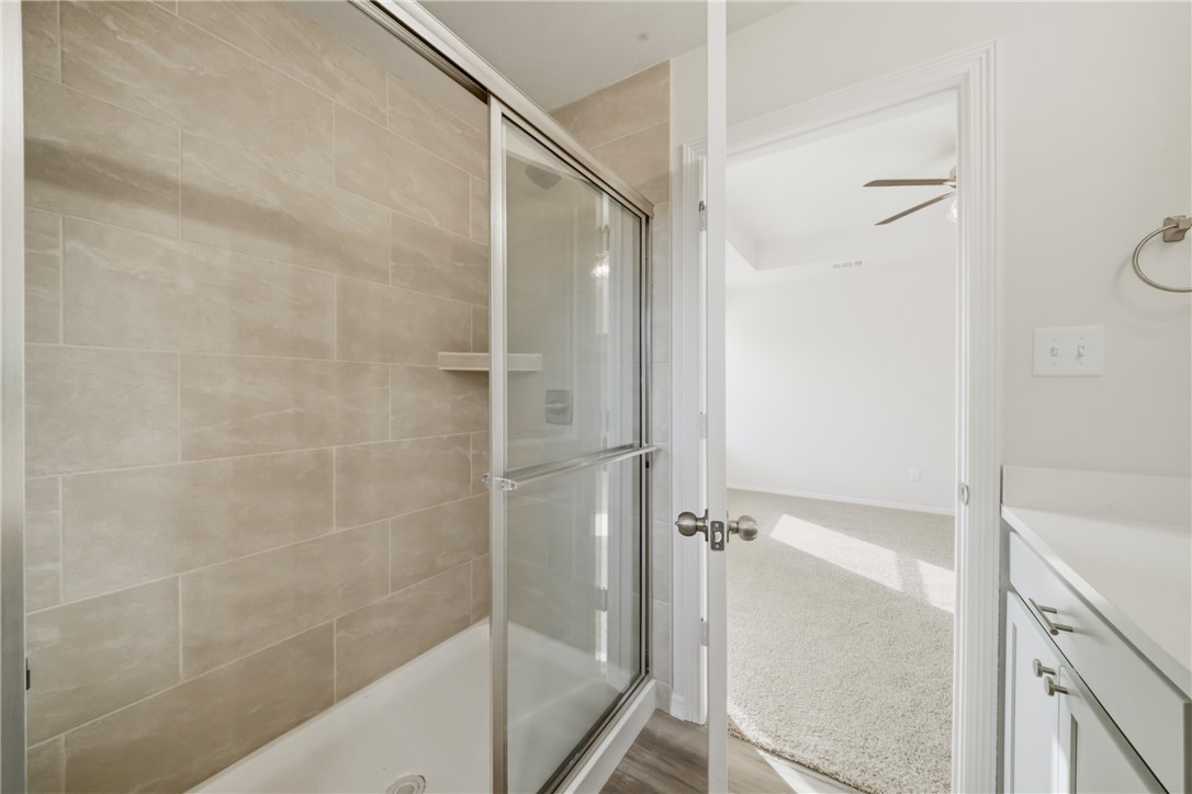 1220 High Street Navasota, TX 77868 - Photo 19 of 27 a bathroom with a glass shower door