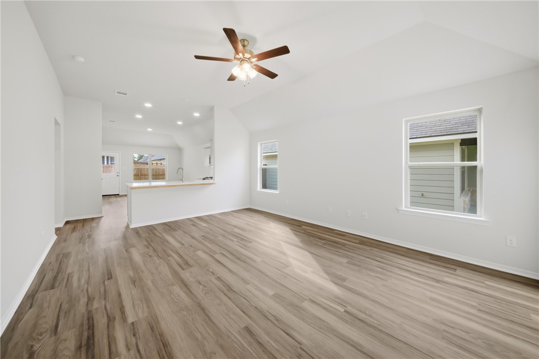 1220 High Street Navasota, TX 77868 - Photo 6 of 27 an empty room with wooden floor and windows