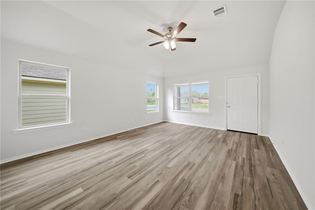 1220 High Street Navasota, TX 77868 - Photo 7 of 27 wooden floor in an empty room with a window