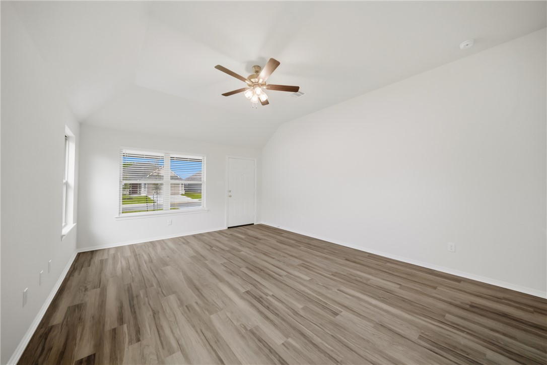 1220 High Street Navasota, TX 77868 - Photo 8 of 27 a view of empty room with wooden floor and fan