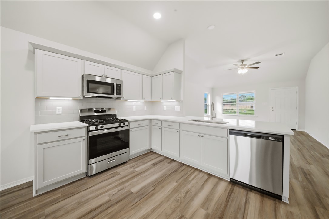 1220 High Street Navasota, TX 77868 - Photo 10 of 27 a kitchen with granite countertop a refrigerator stove top oven and sink