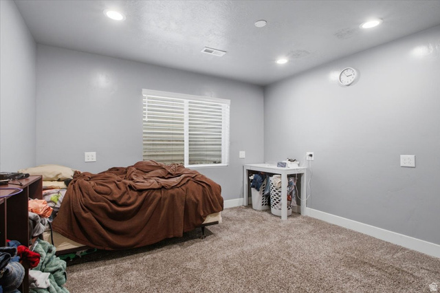 1232 Canyon Road Tooele, UT 84074 - Photo 38 of 54 Room featuring a window with horizontal blinds, neutral-toned walls, recessed lighting, and carpet flooring