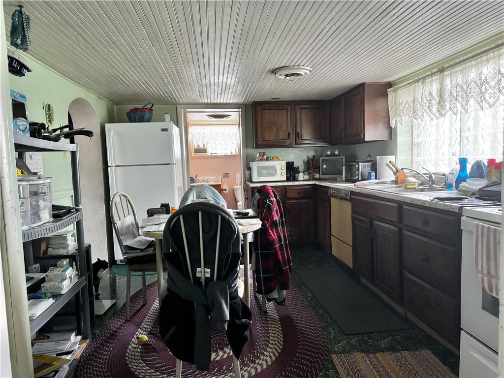 165 Low Hill Road Brownsville, PA 15417 - Photo 19 of 29 a kitchen with a sink a stove a refrigerator and cabinets
