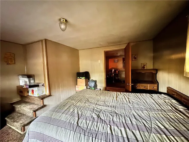 a bedroom with a large bed and a dresser