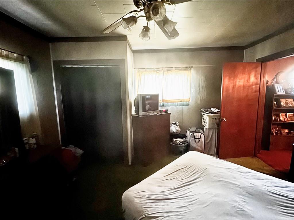 165 Low Hill Road Brownsville, PA 15417 - Photo 26 of 29 a bedroom with a bed and a chandelier