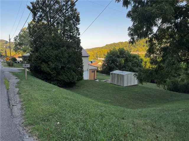 a view of a tiny house with a yard