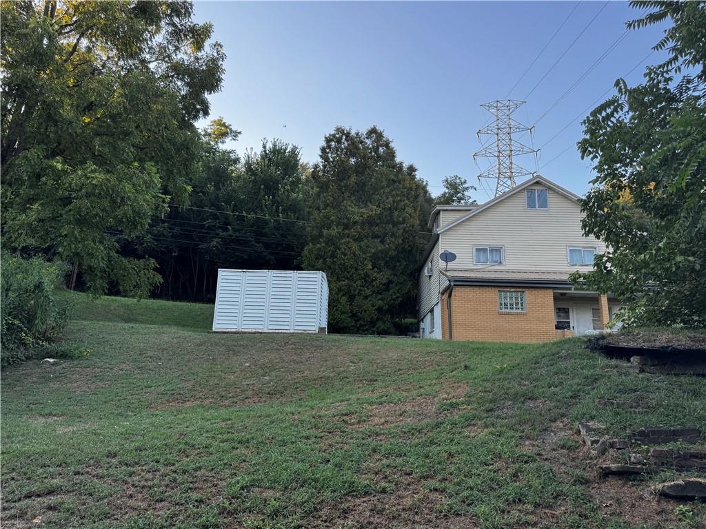 165 Low Hill Road Brownsville, PA 15417 - Photo 6 of 29 a white house that has a tree in front of it