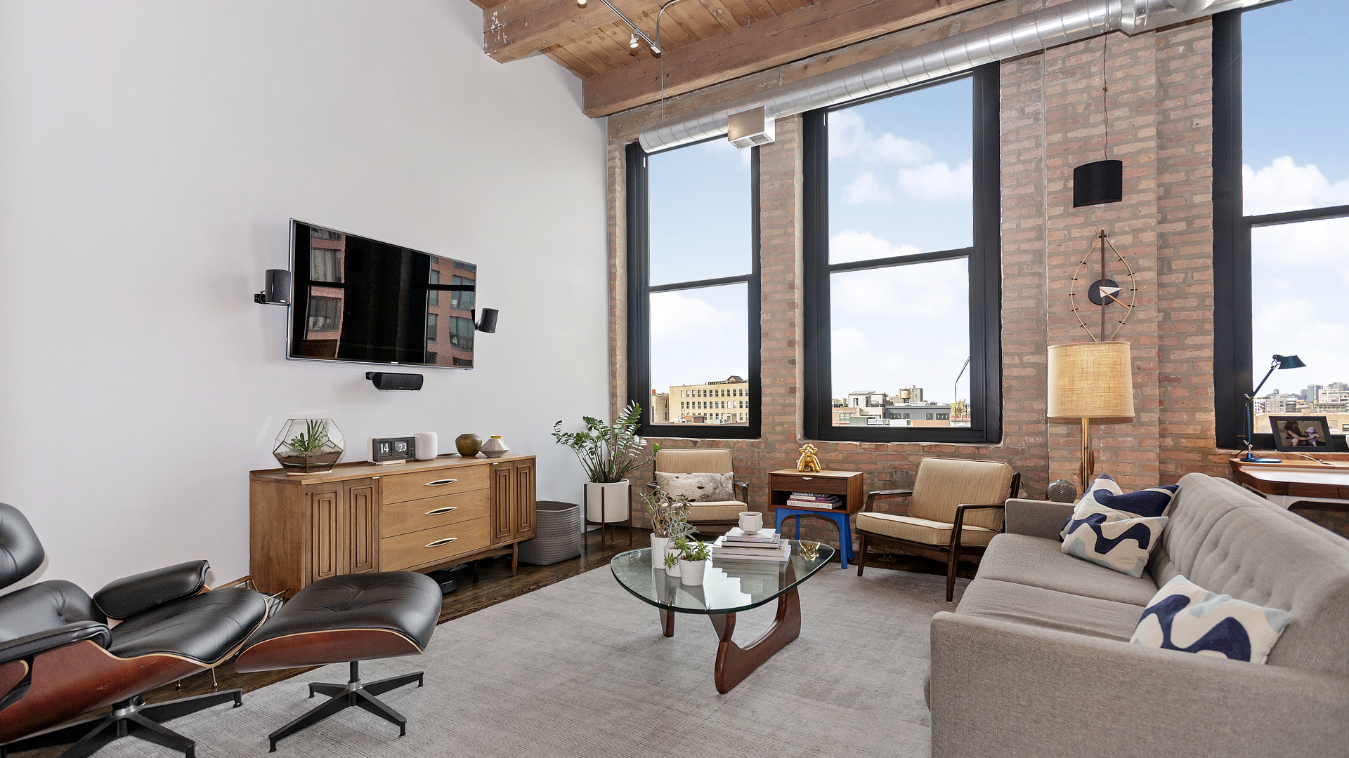 1101 West Lake Street, Unit 5D Chicago, IL 60607 - Photo 2 of 19 a room with furniture and a flat screen tv