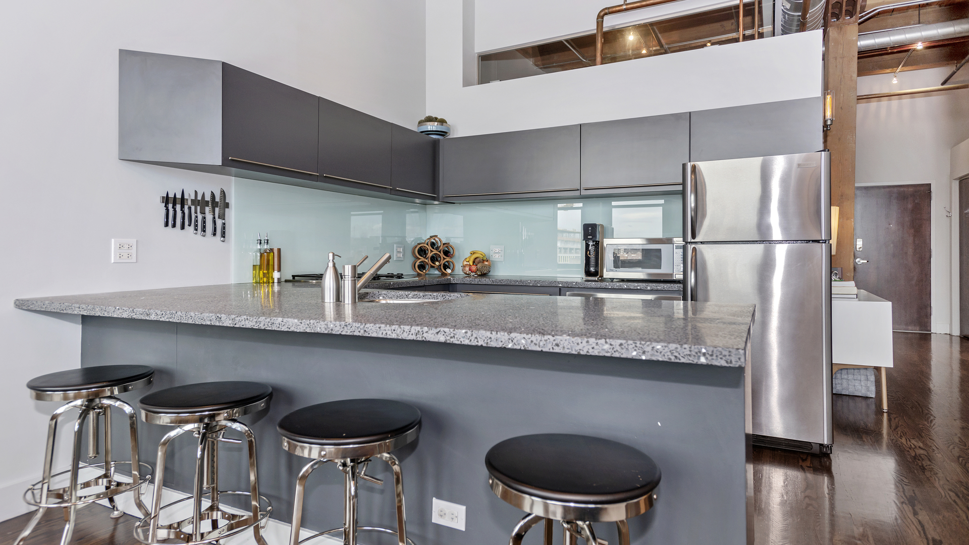 1101 West Lake Street, Unit 5D Chicago, IL 60607 - Photo 7 of 19 a kitchen with stainless steel appliances granite countertop a sink a stove and a refrigerator