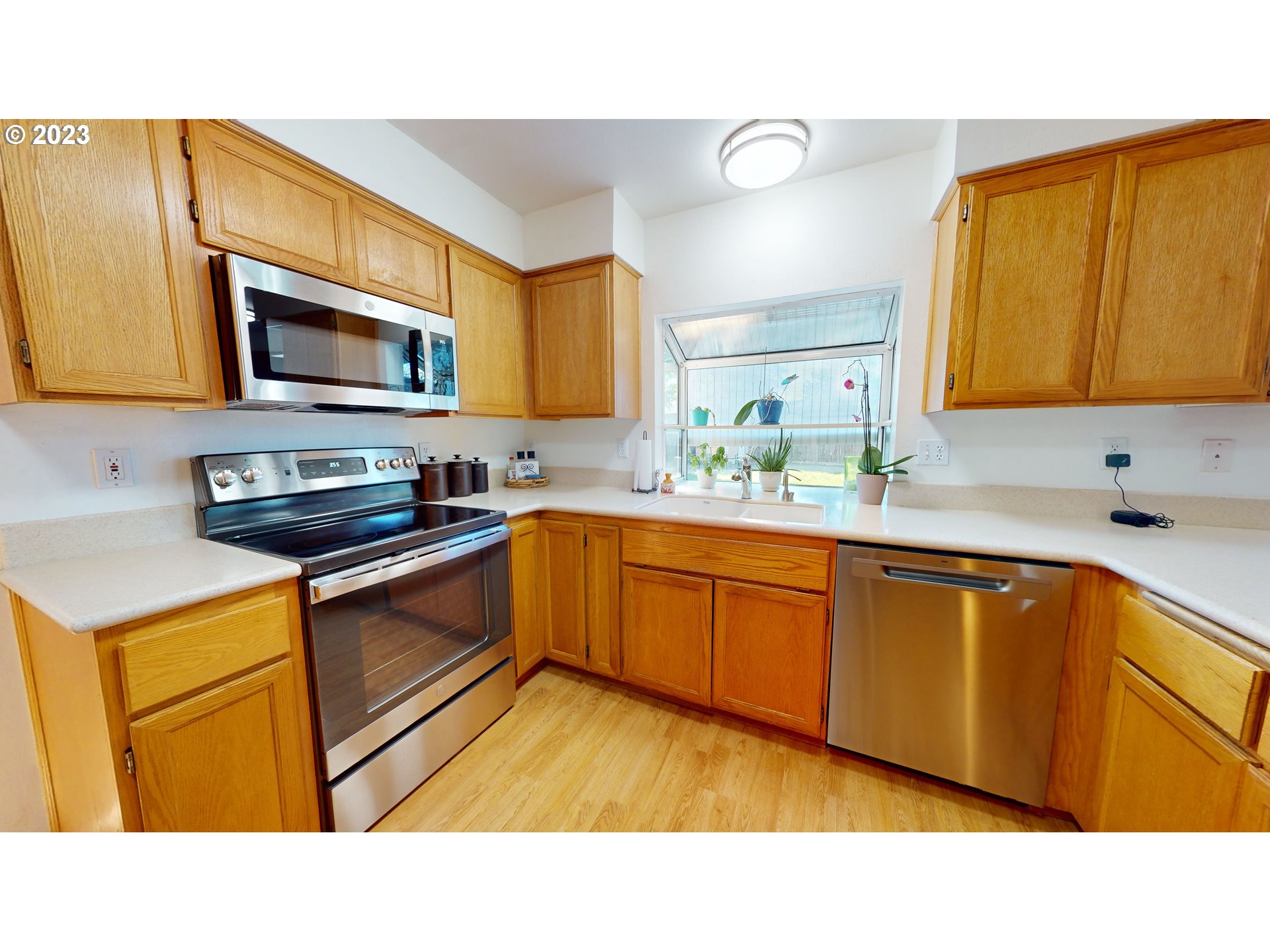 862 South 45th Place Springfield, OR 97478 - Photo 8 of 36 a kitchen with stainless steel appliances granite countertop a sink a stove a microwave cabinets and a counter top space
