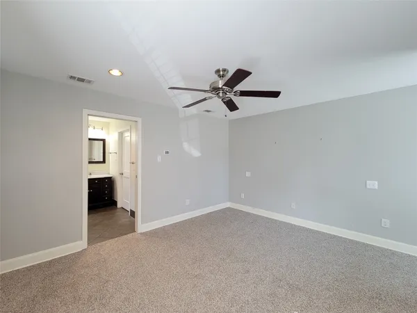 a view of a livingroom with a ceiling fan and window