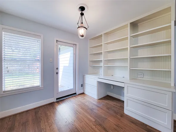 a view of a room with wooden floor and windows