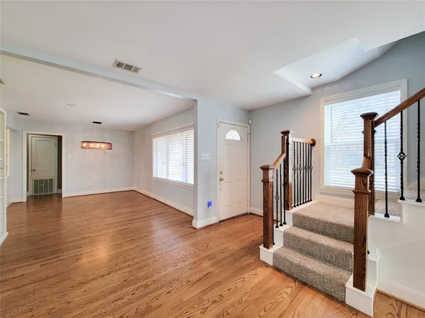 a view of entryway with wooden floor and stairs