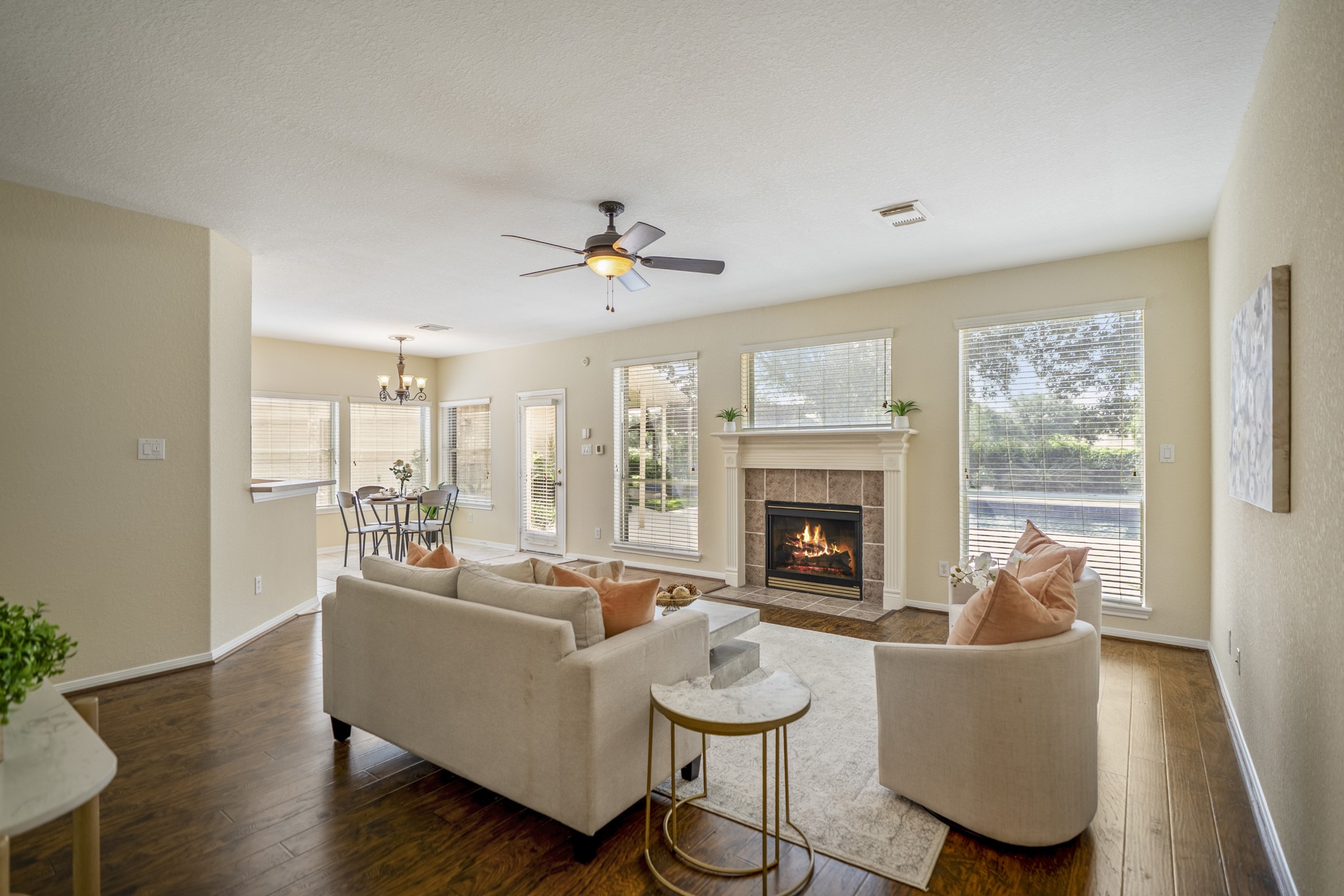 5807 Sequoia Trace Court Spring, TX 77379 - Photo 8 of 50 The family room brings the Windrose lifestyle right into view, with large windows overlooking the pool, spa, and golf course backdrop, plus a fireplace and laminate flooring that keep the space warm and inviting.