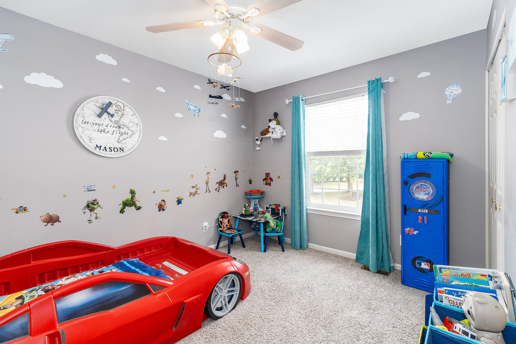 1950 Lakeside Drive Montgomery, IL 60538 - Photo 12 of 15 a bedroom with a bed and a chandelier