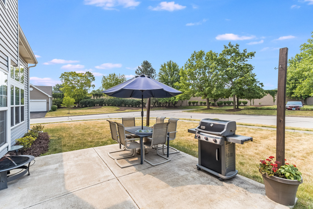 1950 Lakeside Drive Montgomery, IL 60538 - Photo 14 of 15 a view of a patio with a table and chairs under an umbrella