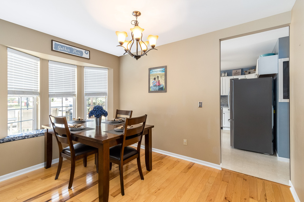 1950 Lakeside Drive Montgomery, IL 60538 - Photo 4 of 15 a view of a dining room with furniture a chandelier and wooden floor