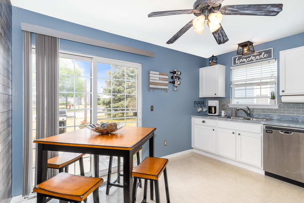 1950 Lakeside Drive Montgomery, IL 60538 - Photo 6 of 15 a kitchen with a table chairs sink and cabinets