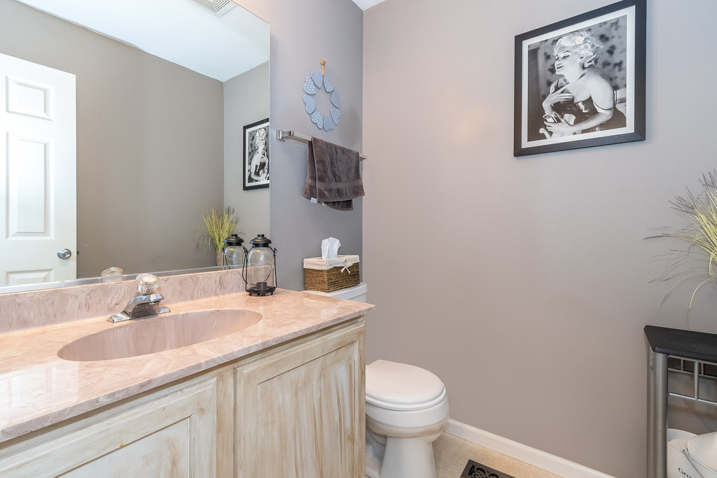 1950 Lakeside Drive Montgomery, IL 60538 - Photo 7 of 15 a bathroom with a granite countertop sink mirror vanity and toilet