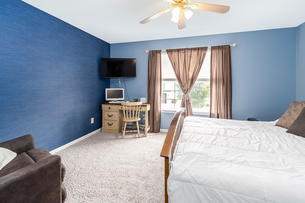 1950 Lakeside Drive Montgomery, IL 60538 - Photo 9 of 15 a bedroom with a bed and a flat screen tv