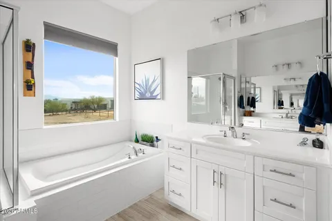 a bathroom with a tub a sink and mirror