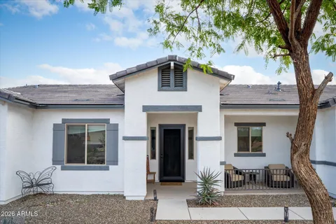 a front view of a house with outdoor seating