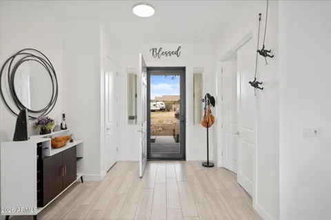 a view of a hallway with wooden floor and entryway
