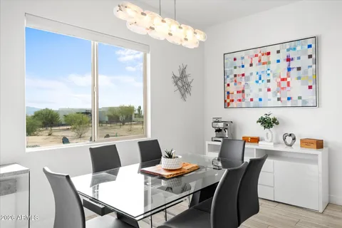 a dining room with furniture a large window and a chandelier