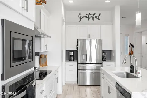 a kitchen with a refrigerator sink and stove