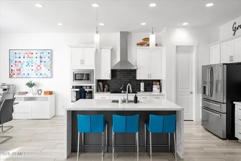 a kitchen with stainless steel appliances granite countertop a stove a sink a refrigerator and a refrigerator