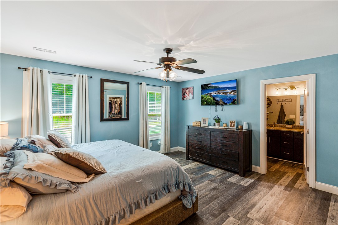 842 Conneross Road Townville, SC 29689 - Photo 15 of 34 Well-lit bedroom offers a ceiling fan, durable flooring, and convenient en-suite access.