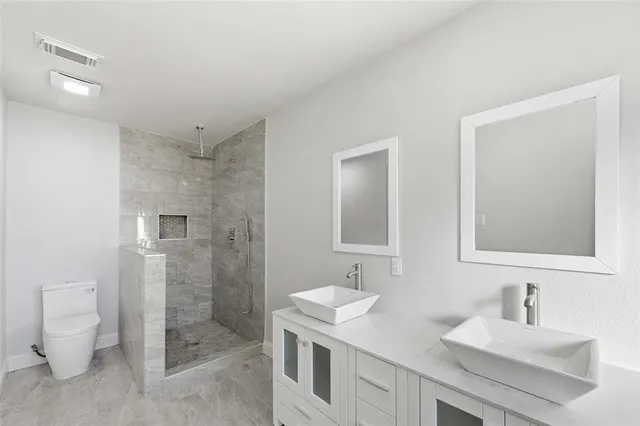 a bathroom with a sink toilet and shower