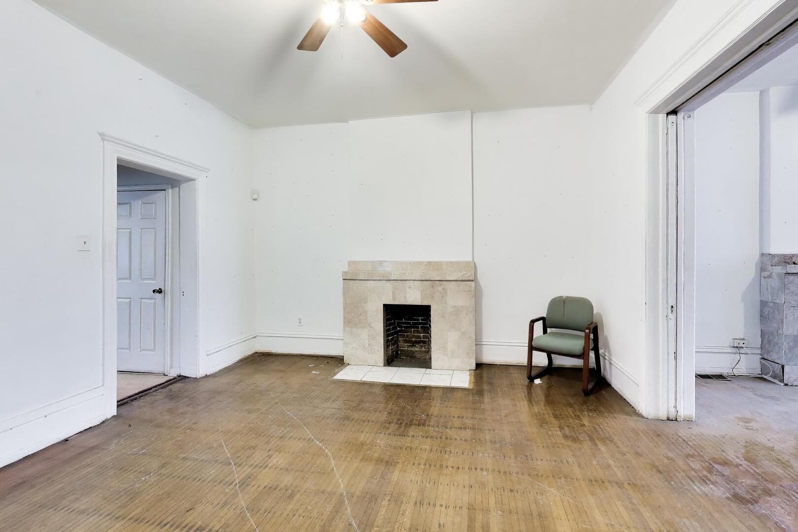 4505 South Indiana Avenue Chicago, IL 60653 - Photo 6 of 31 a view of a livingroom with a fireplace and a window