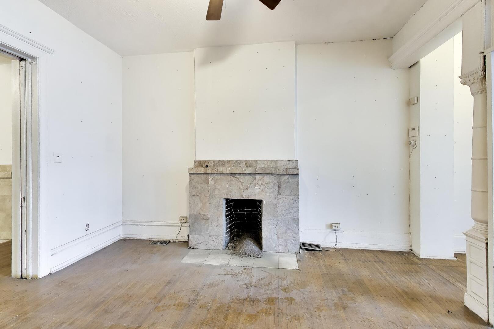 4505 South Indiana Avenue Chicago, IL 60653 - Photo 10 of 31 a view of an empty room with a fireplace and a window