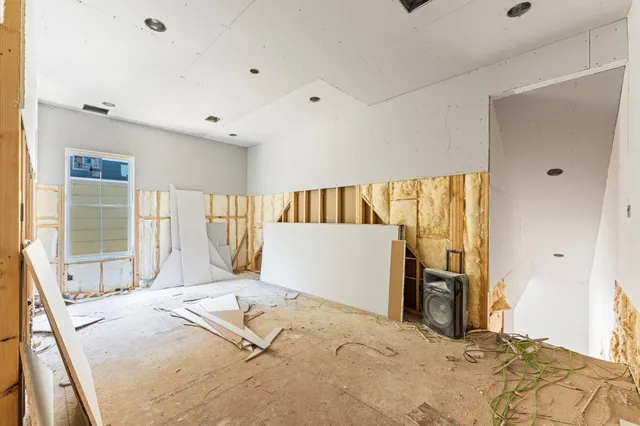 a bedroom with a large bed and a large window