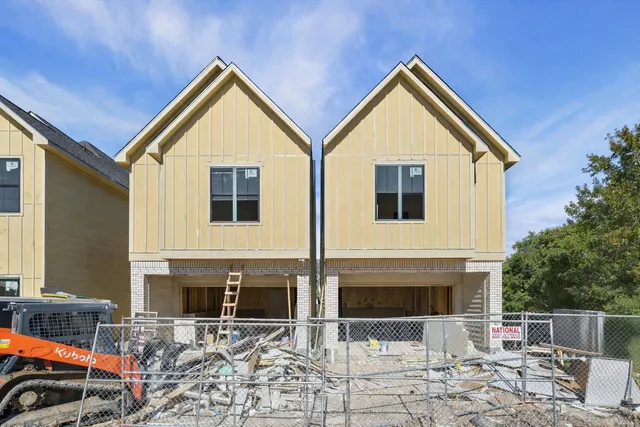 a view of house with yard and sitting area