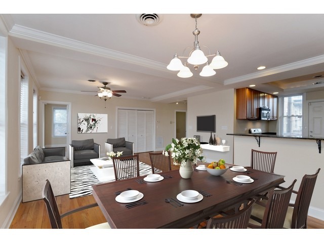 4105 North Sheridan Road, Unit 3N Chicago, IL 60613 - Photo 3 of 10 a view of a dining room with furniture and a chandelier