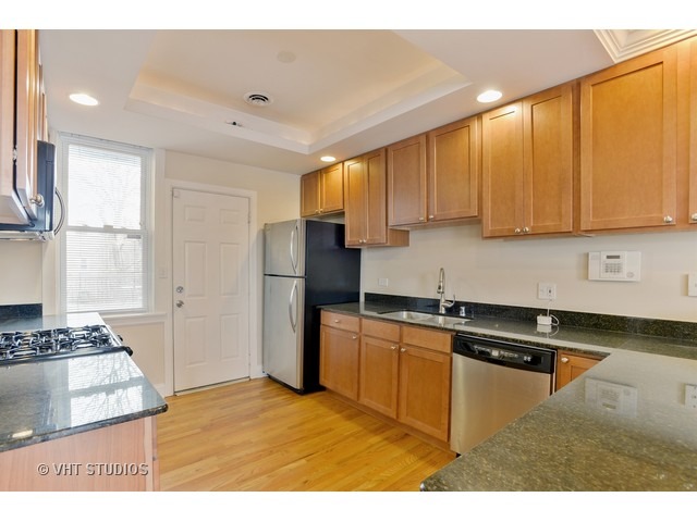 4105 North Sheridan Road, Unit 3N Chicago, IL 60613 - Photo 4 of 10 a kitchen with stainless steel appliances granite countertop a stove a sink dishwasher and a refrigerator