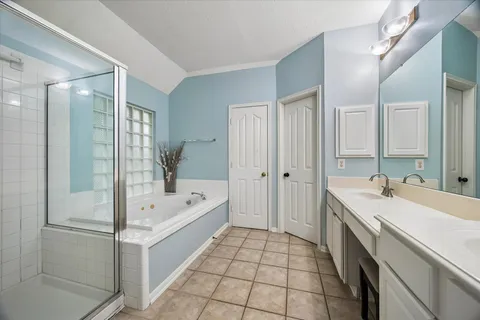 a bathroom with a tub a sink and mirrors