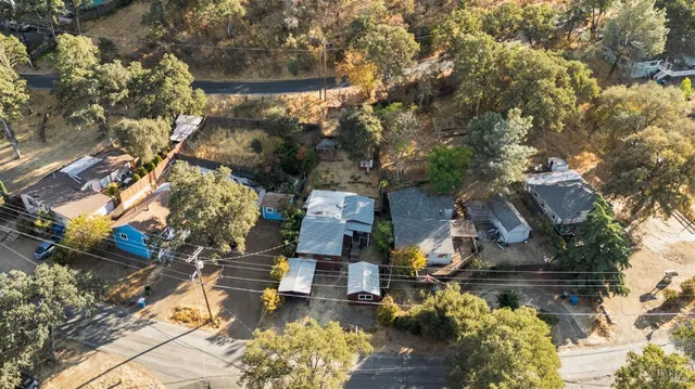 an aerial view of a house with yard and sitting area