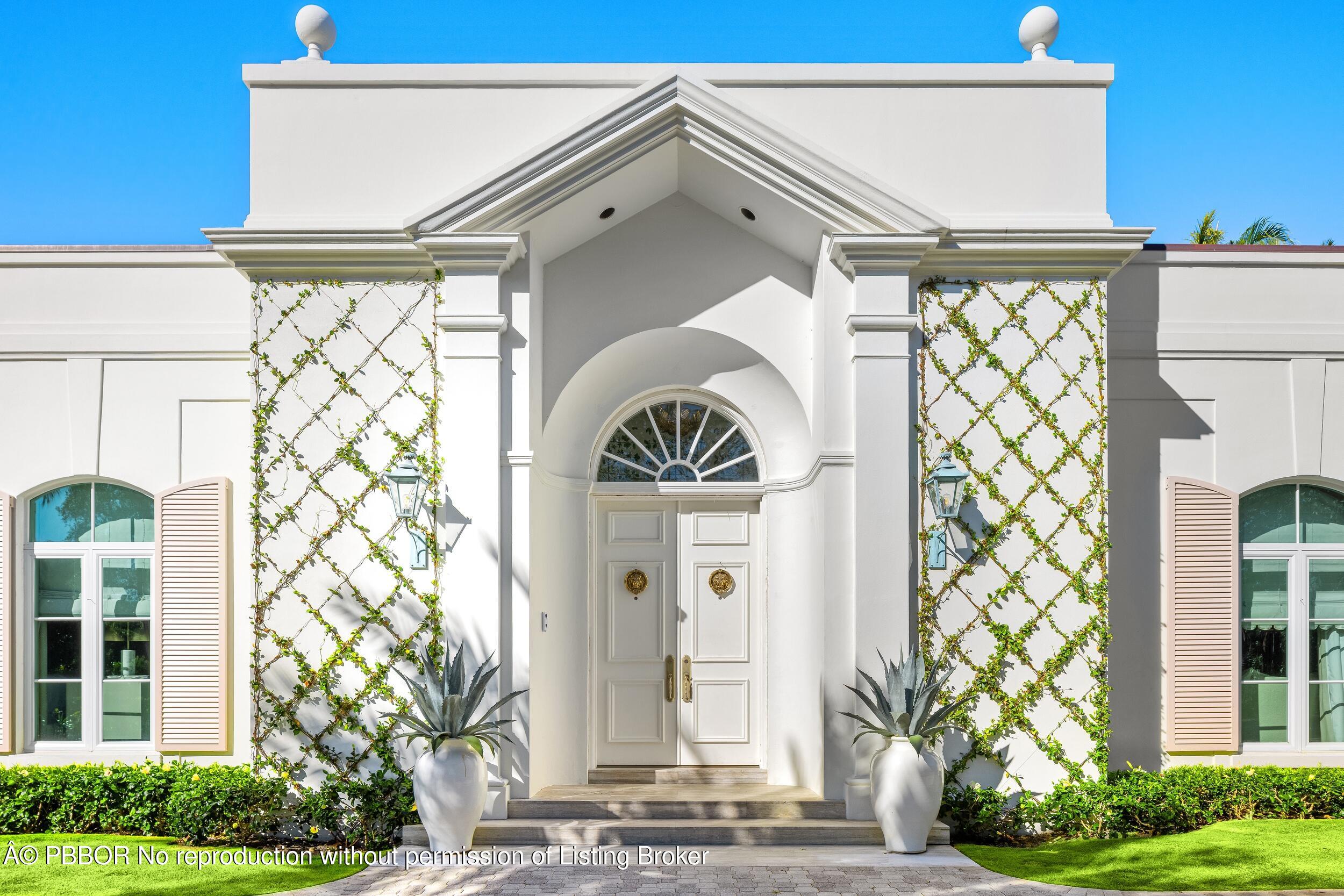 309 Chapel Hill Road Palm Beach, FL 33480 - Photo 3 of 50 a front view of a house with a garden
