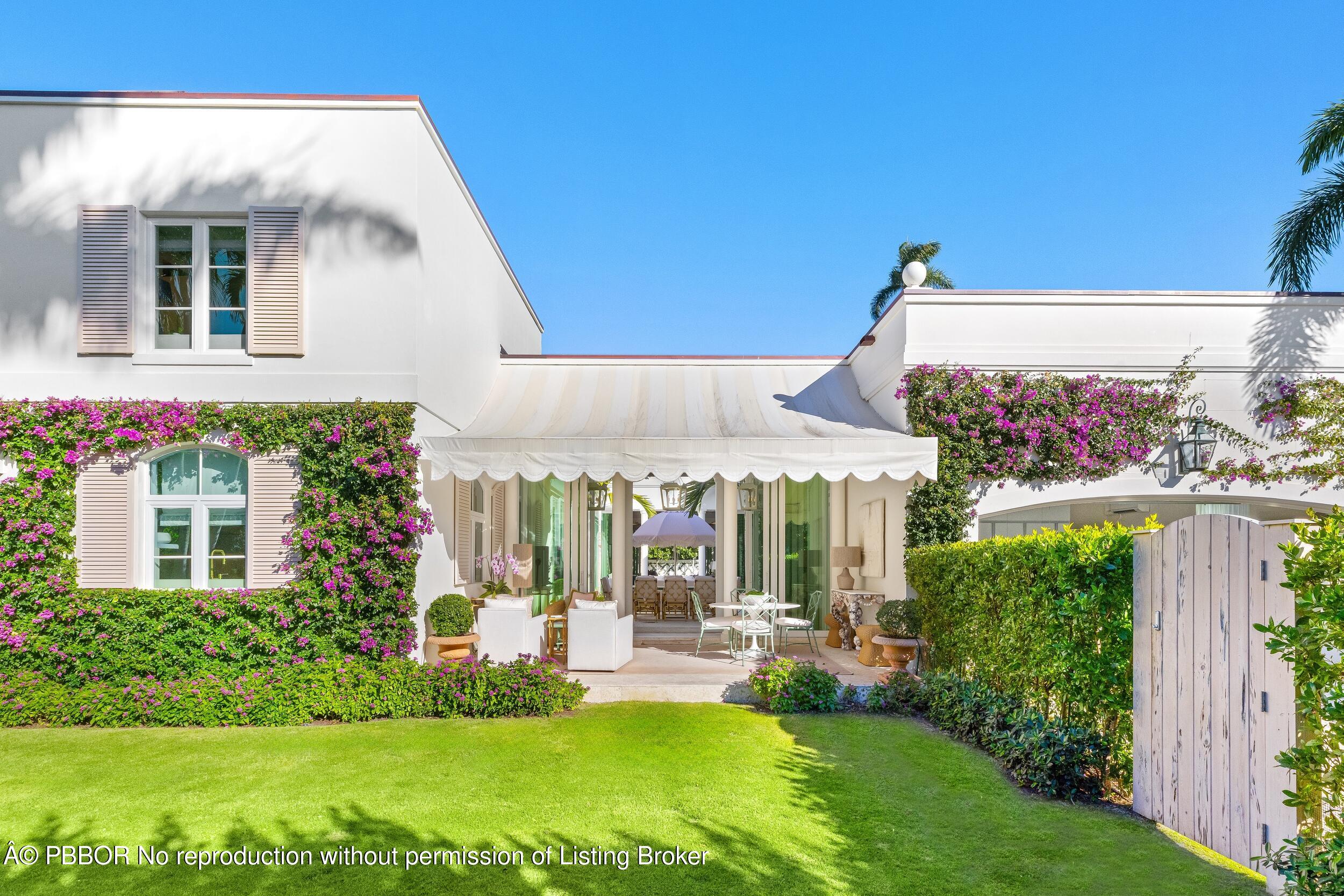 309 Chapel Hill Road Palm Beach, FL 33480 - Photo 42 of 50 a view of a house with backyard and a garden