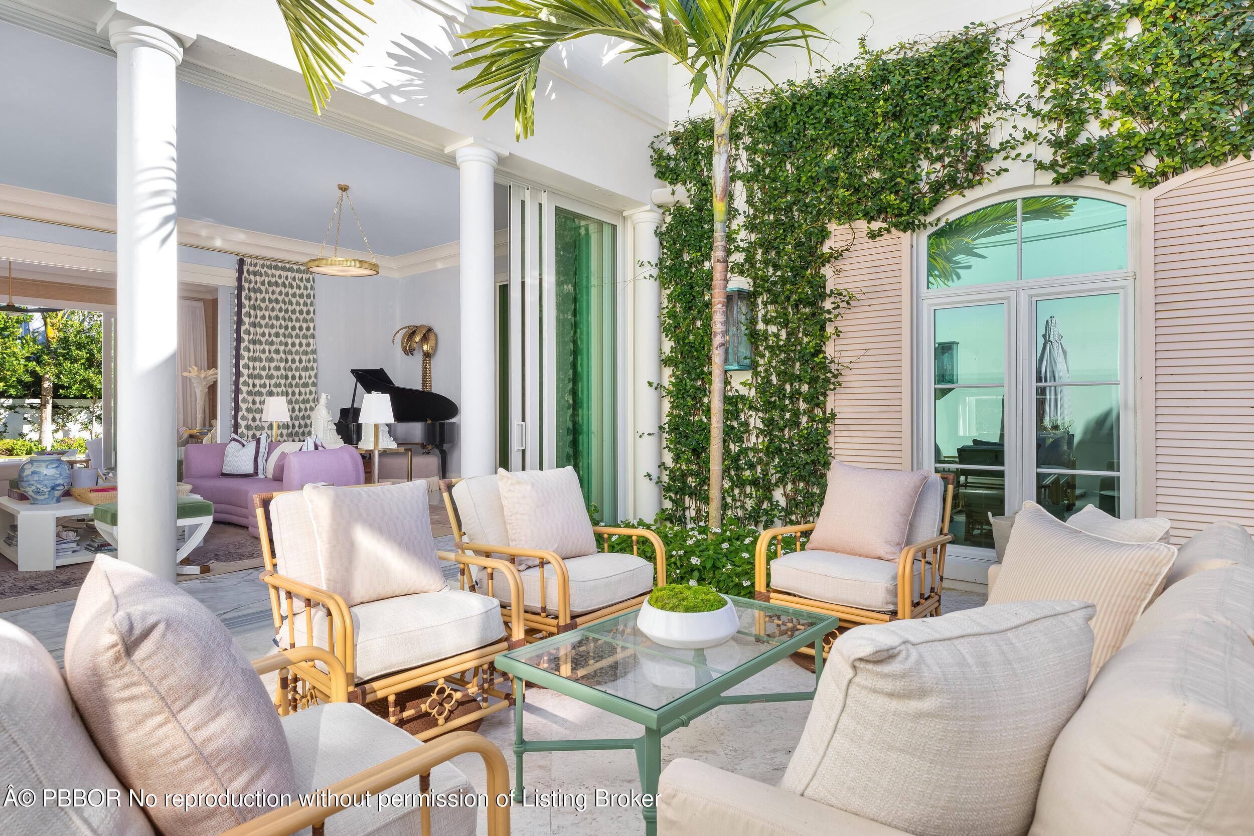 309 Chapel Hill Road Palm Beach, FL 33480 - Photo 7 of 50 a view of a patio with couches table and chairs and potted plants