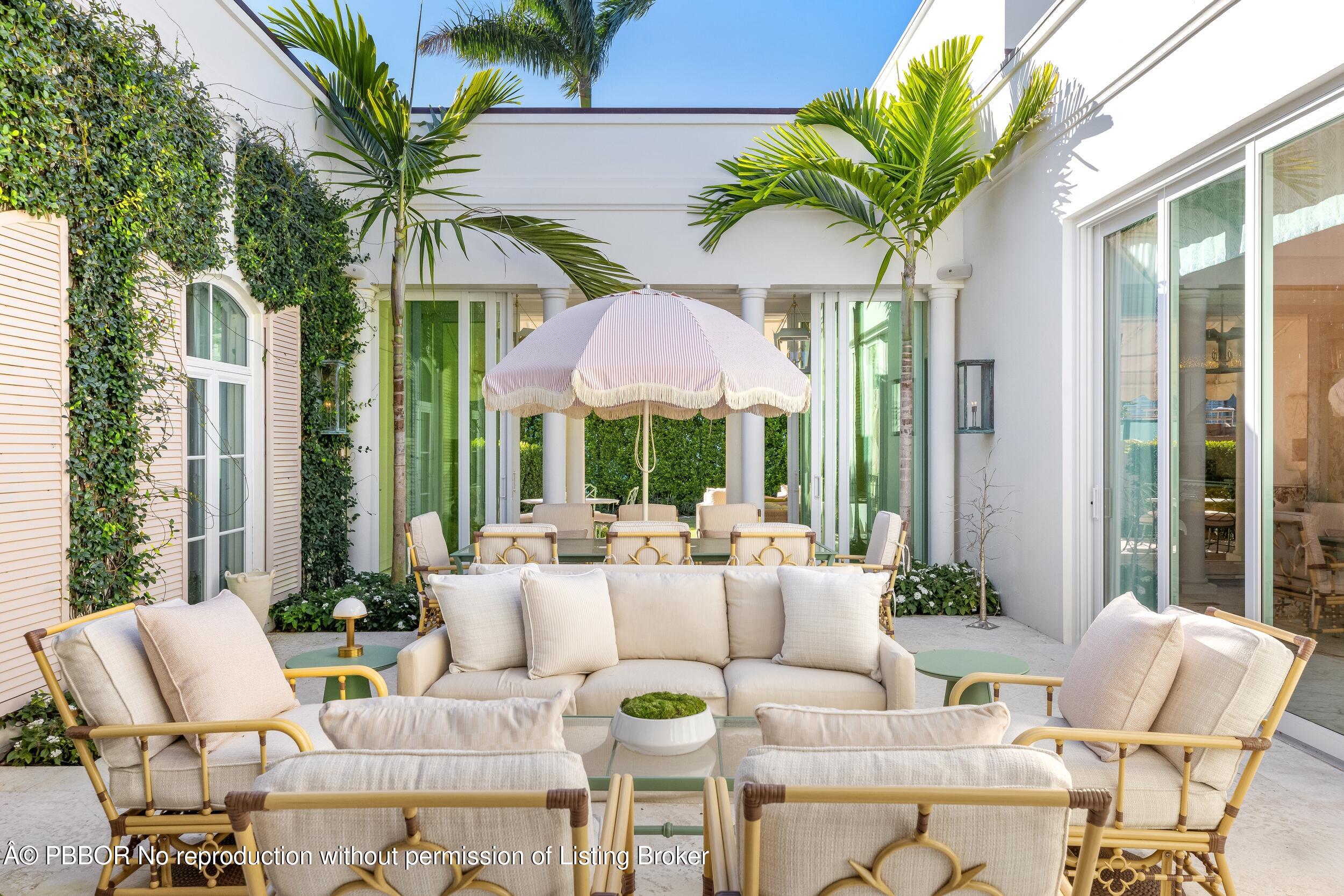 309 Chapel Hill Road Palm Beach, FL 33480 - Photo 8 of 50 a view of a patio with couches chairs and a potted plants