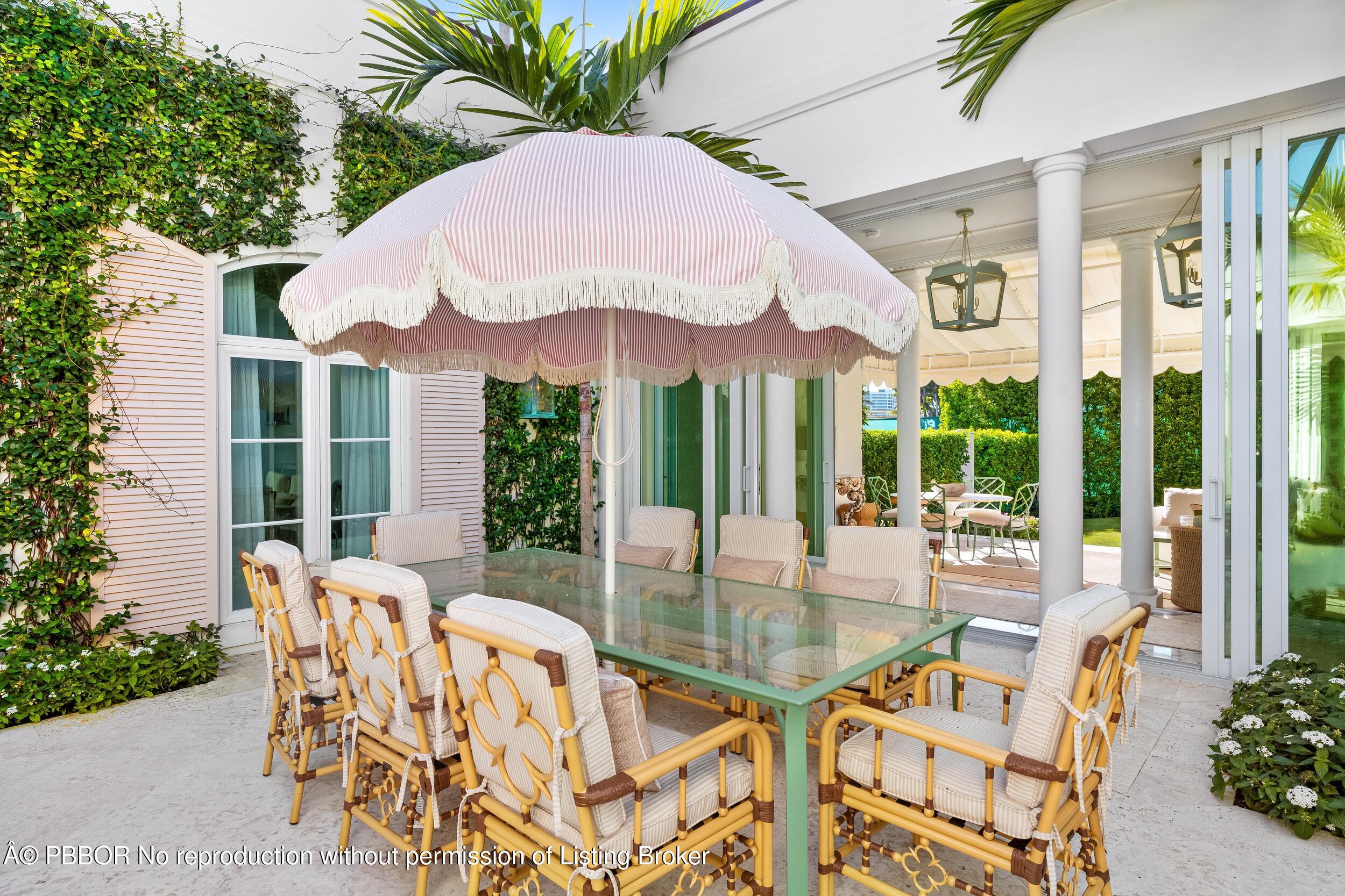 309 Chapel Hill Road Palm Beach, FL 33480 - Photo 9 of 50 a view of a patio with a table chairs and a small yard