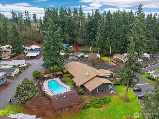 an aerial view of a house with garden space and street view